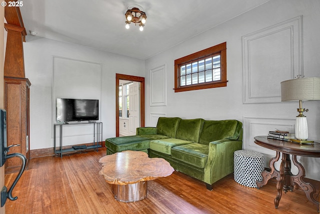 living room with baseboards and wood finished floors