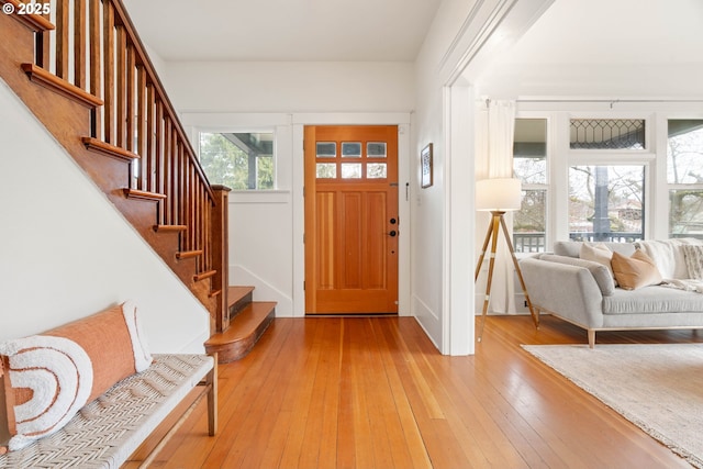 foyer entrance with stairway and light wood-type flooring