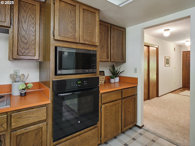 135 Ridgecrest Dr, Toledo, WA 98591 - kitchen with oven, stainless steel microwave, light countertops, and brown cabinets