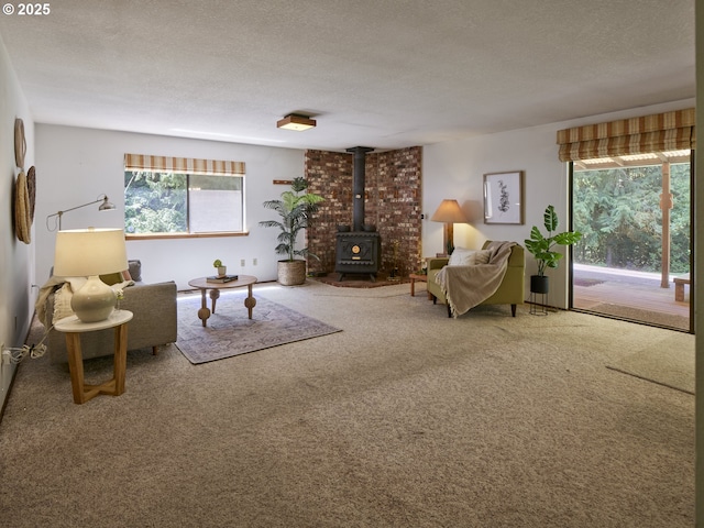 135 Ridgecrest Dr, Toledo, WA 98591 - carpeted living area featuring a wood stove, plenty of natural light, and a textured ceiling