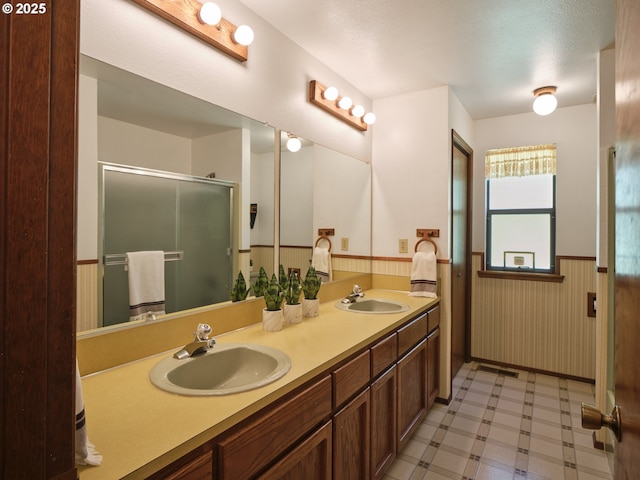135 Ridgecrest Dr, Toledo, WA 98591 - bathroom with wainscoting, double vanity, a stall shower, and tile patterned floors