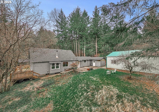 29815 NE 152nd Ave, Battle Ground, WA 98604 - rear view of house with a lawn, an outbuilding, a wooden deck, roof with shingles, and a garage