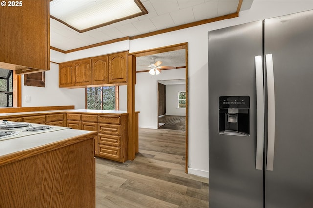 29815 NE 152nd Ave, Battle Ground, WA 98604 - kitchen featuring stainless steel refrigerator with ice dispenser, crown molding, brown cabinets, light wood-style floors, and a ceiling fan