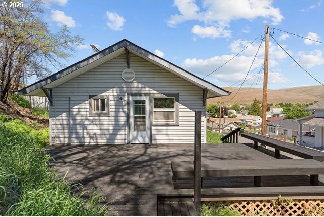 back of house with a deck