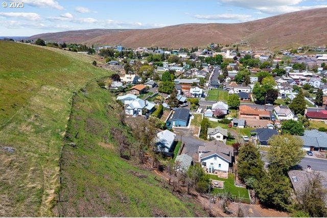 aerial overview of property's location featuring mountains and nearby suburban area
