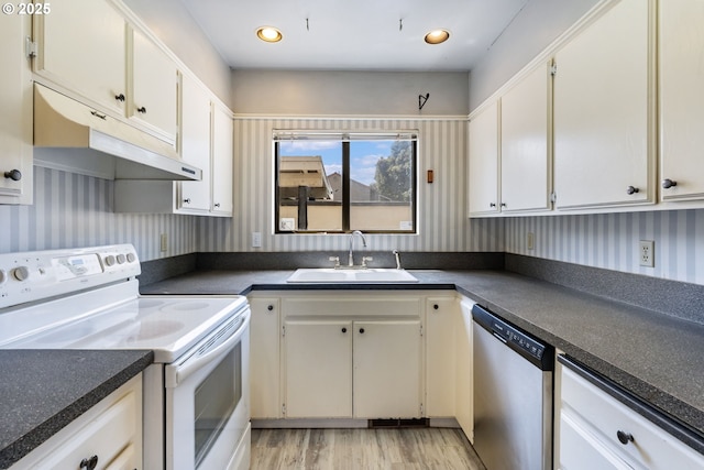 224 N Hayden Bay Dr, Portland, OR 97217 - kitchen featuring electric stove, stainless steel dishwasher, under cabinet range hood, wallpapered walls, and light wood-style flooring