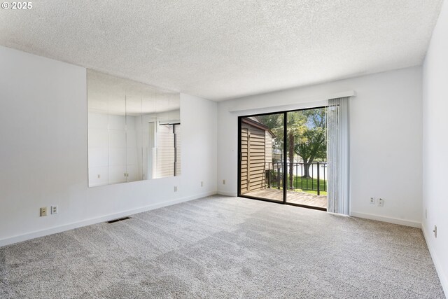 224 N Hayden Bay Dr, Portland, OR 97217 - spare room with a textured ceiling and carpet flooring