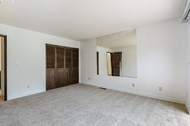 224 N Hayden Bay Dr, Portland, OR 97217 - unfurnished bedroom with carpet flooring, a textured ceiling, and a closet