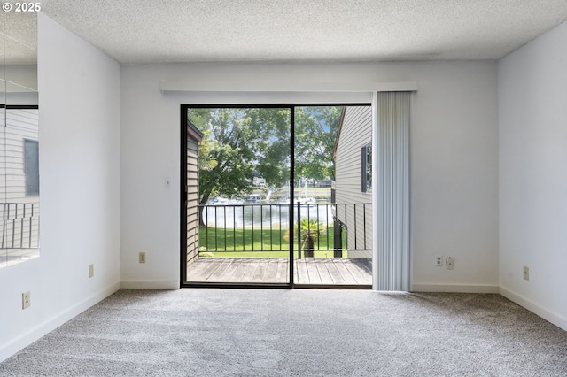 224 N Hayden Bay Dr, Portland, OR 97217 - empty room featuring carpet flooring and a textured ceiling
