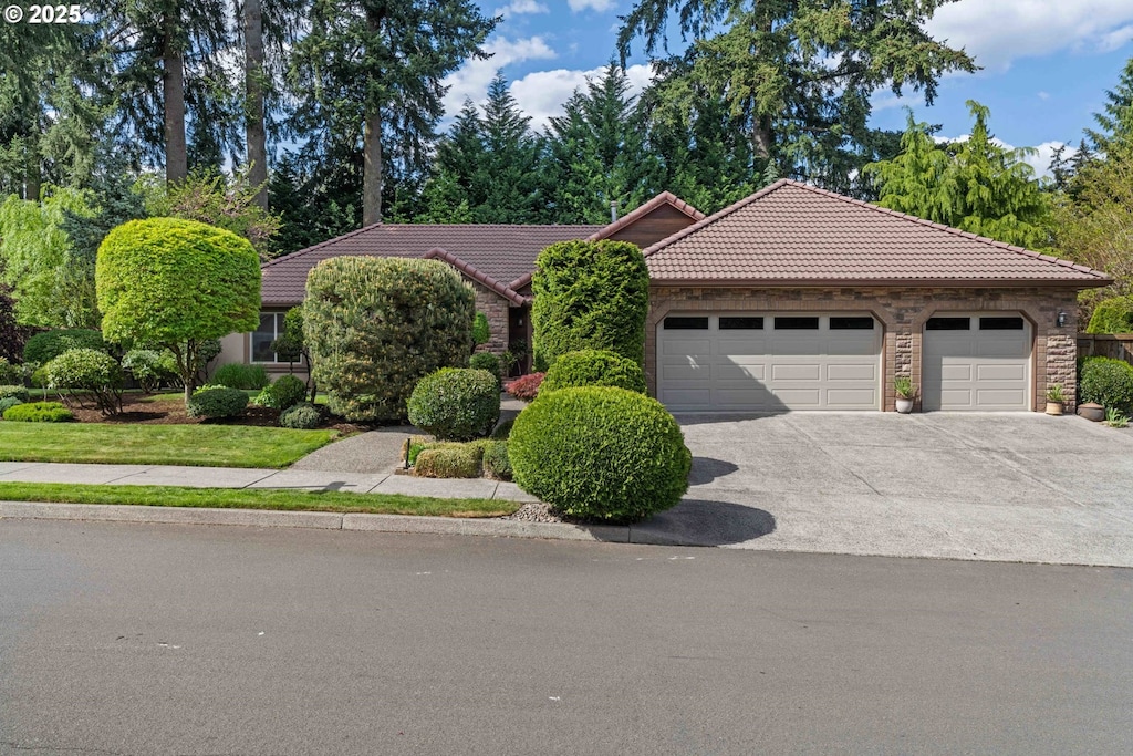 14600 NE 16th St, Vancouver, WA 98684 - view of front of property featuring a tiled roof, an attached garage, and driveway