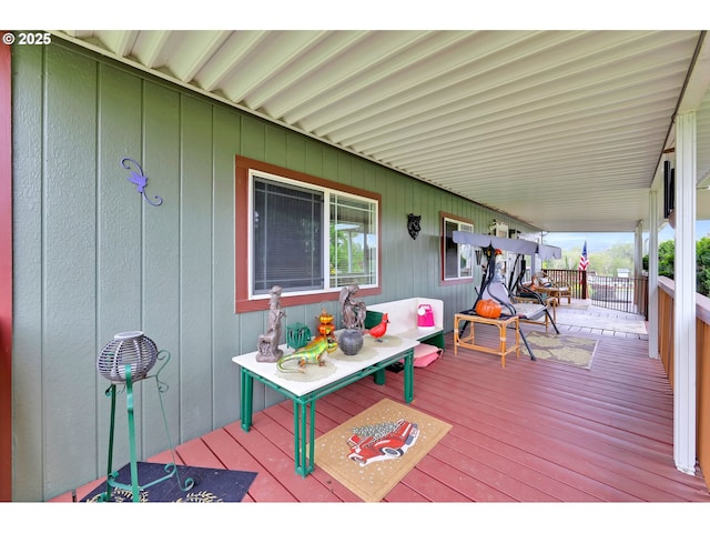 wooden terrace featuring covered porch