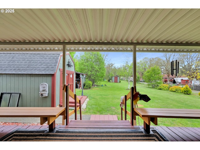 deck with an outdoor structure, a shed, and a yard