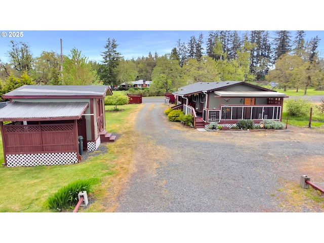 view of front of house with a porch and dirt driveway