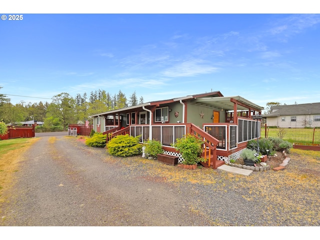 manufactured / mobile home with a porch and fence