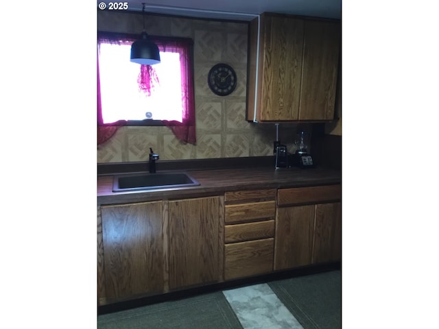 kitchen featuring a sink and dark countertops