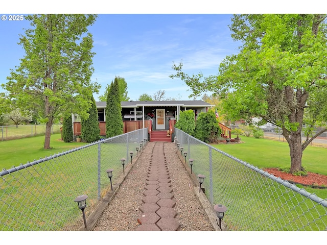 view of front of property with fence private yard and a front lawn