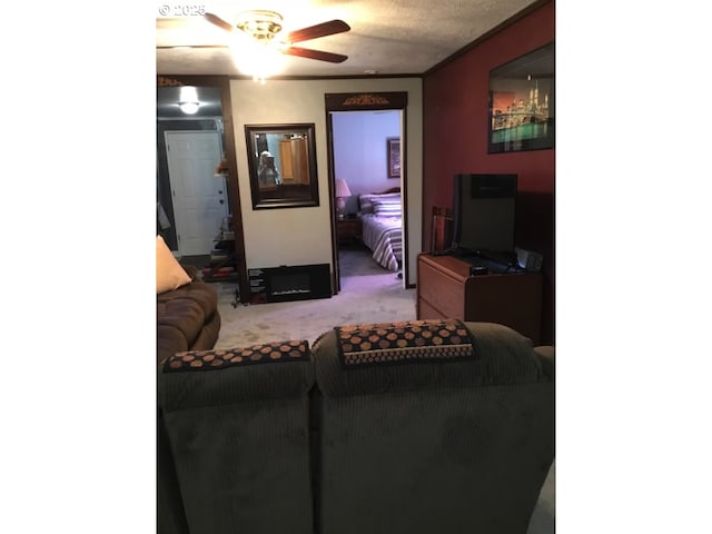 living room featuring carpet flooring and ceiling fan