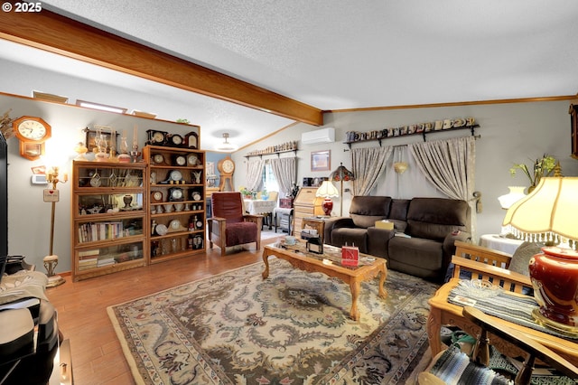 39028 Dexter Rd, Dexter, OR 97431 - living area with lofted ceiling with beams, a textured ceiling, a wall unit AC, and wood finished floors