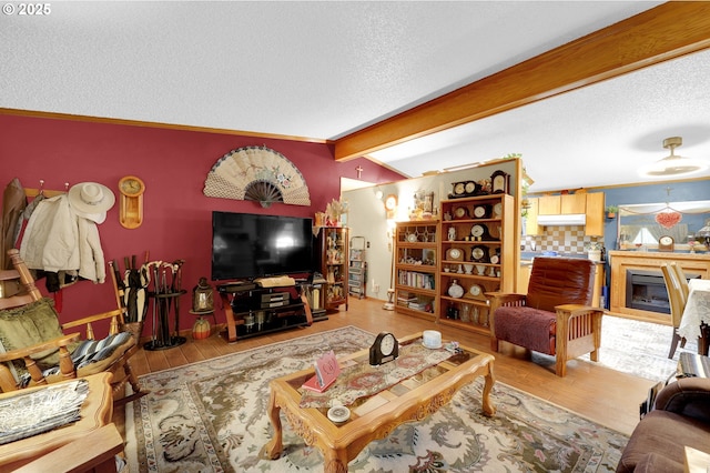 39028 Dexter Rd, Dexter, OR 97431 - living room with a textured ceiling, vaulted ceiling with beams, a fireplace, and wood finished floors