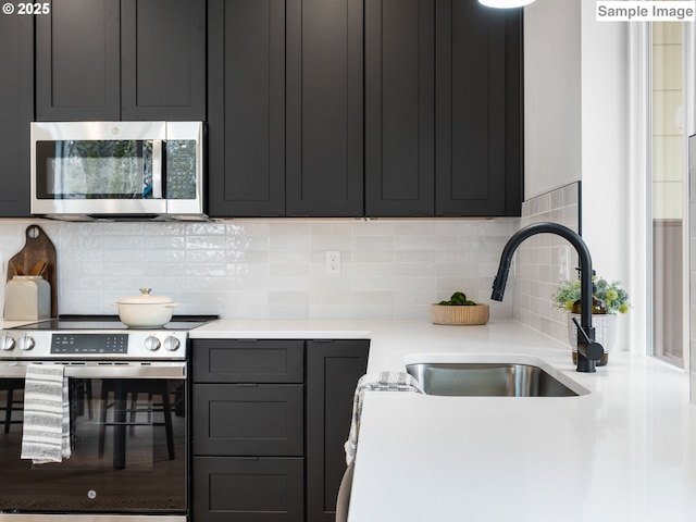 7195 SE Crystal Springs Blvd Unit 7, Portland, OR 97206 - kitchen featuring appliances with stainless steel finishes, light countertops, and tasteful backsplash