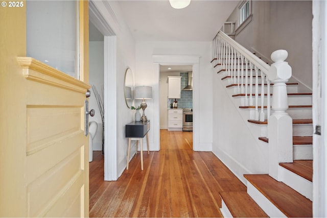 entrance foyer featuring wood-type flooring and stairway