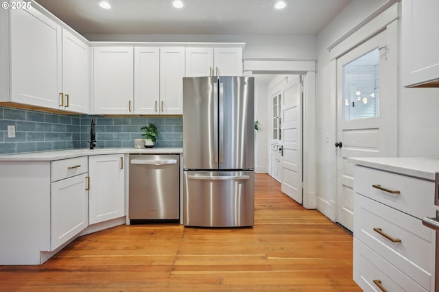 kitchen with light countertops, recessed lighting, appliances with stainless steel finishes, and a sink