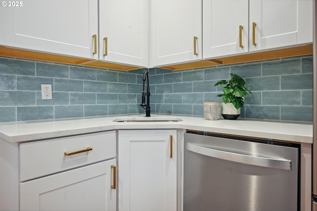 details featuring dishwasher, white cabinetry, light stone counters, a sink, and backsplash
