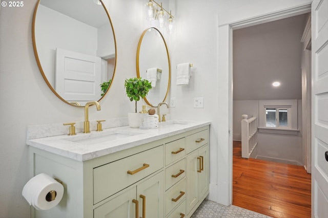 bathroom with double vanity, recessed lighting, a sink, and wood finished floors