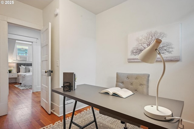 office space featuring baseboards and hardwood / wood-style flooring