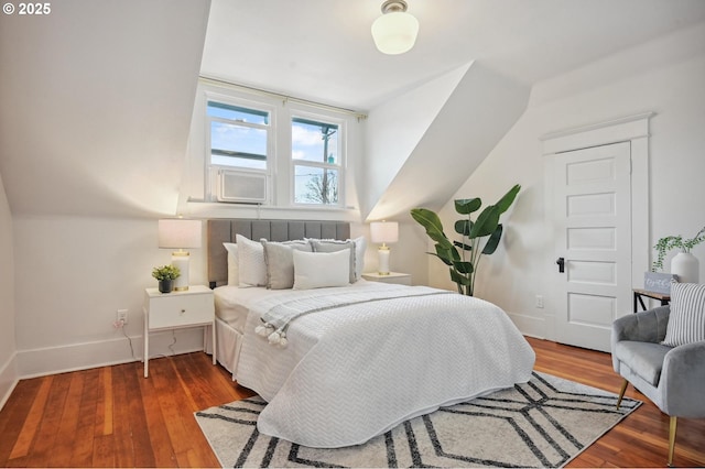 bedroom featuring baseboards, wood finished floors, and cooling unit
