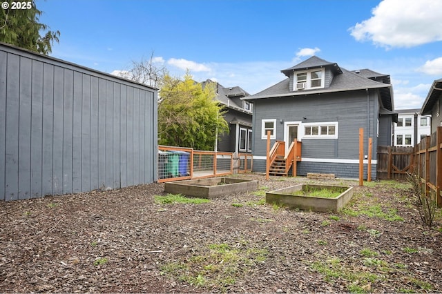 4131 NE Cleveland Ave, Portland, OR 97211 - rear view of property with a vegetable garden
