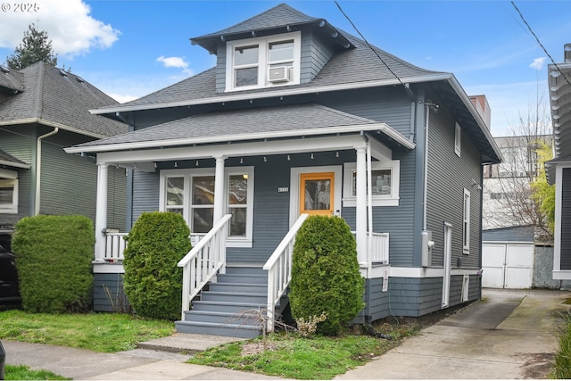 4131 NE Cleveland Ave, Portland, OR 97211 - view of front of home featuring a porch, roof with shingles, cooling unit, and a detached garage