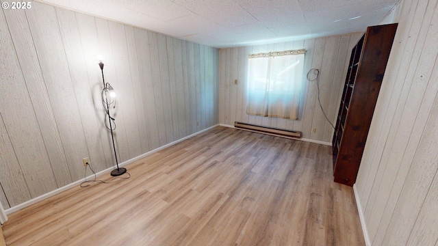 33080 Lupine Way Rd, Gold Beach, OR 97444 - empty room with a baseboard radiator, wood finished floors, and wood walls