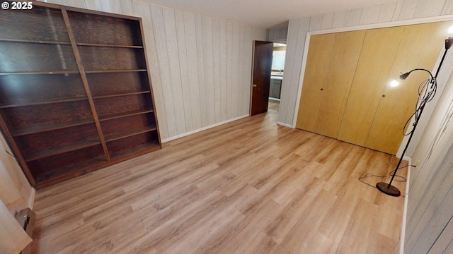 33080 Lupine Way Rd, Gold Beach, OR 97444 - unfurnished bedroom featuring wood finished floors, wood walls, and a closet