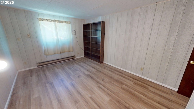 33080 Lupine Way Rd, Gold Beach, OR 97444 - spare room with a baseboard heating unit, wood walls, and wood finished floors