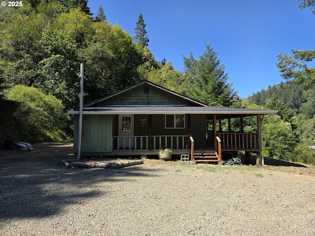 33080 Lupine Way Rd, Gold Beach, OR 97444 - view of front of property featuring a porch and a view of trees