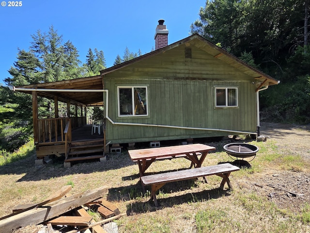 33080 Lupine Way Rd, Gold Beach, OR 97444 - back of property with a chimney, an outdoor fire pit, and a wooden deck