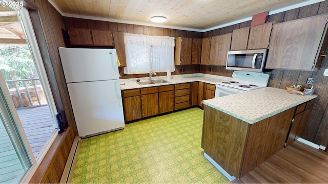 33080 Lupine Way Rd, Gold Beach, OR 97444 - kitchen with white appliances, wooden walls, a peninsula, light countertops, and light flooring