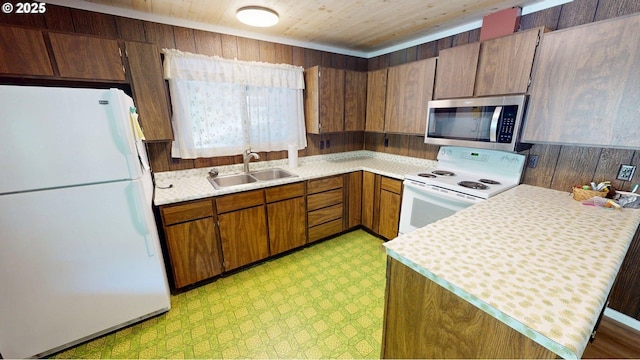 33080 Lupine Way Rd, Gold Beach, OR 97444 - kitchen featuring white appliances, light floors, light countertops, wood ceiling, and brown cabinetry