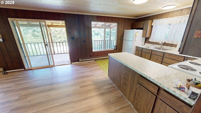 33080 Lupine Way Rd, Gold Beach, OR 97444 - kitchen with a baseboard heating unit, freestanding refrigerator, light countertops, light wood-type flooring, and wood walls