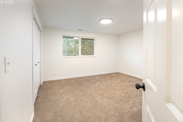 unfurnished bedroom with a closet, visible vents, baseboards, and carpet floors