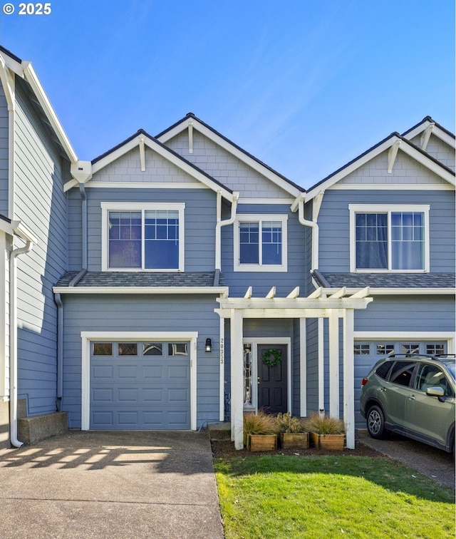 view of front of house featuring a garage and a front lawn