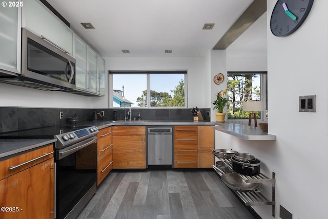 3109 NW Neptune Ave, Lincoln City, OR 97367 - kitchen featuring stainless steel appliances, dark wood-type flooring, modern cabinets, and brown cabinets
