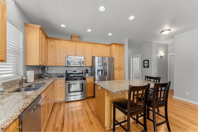 521 Wildcat Canyon Rd, Sutherlin, OR 97479 - kitchen featuring stainless steel appliances, a sink, light wood finished floors, a kitchen breakfast bar, and light brown cabinets