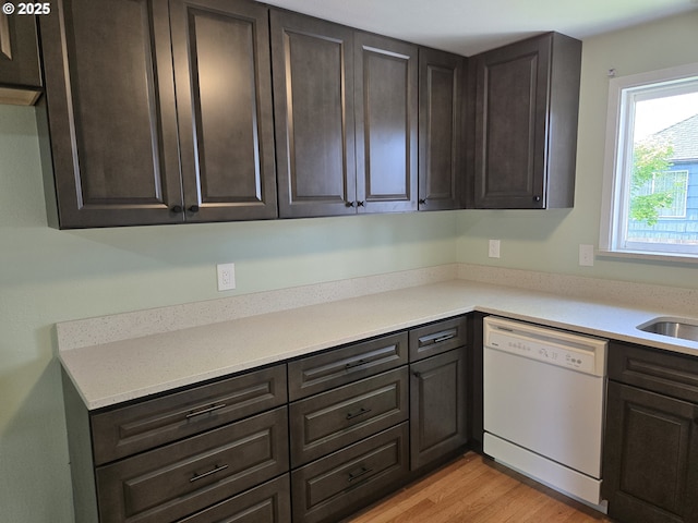 1625 Jackson St, Albany, OR 97322 - kitchen with white dishwasher, dark brown cabinets, light countertops, and light wood-type flooring