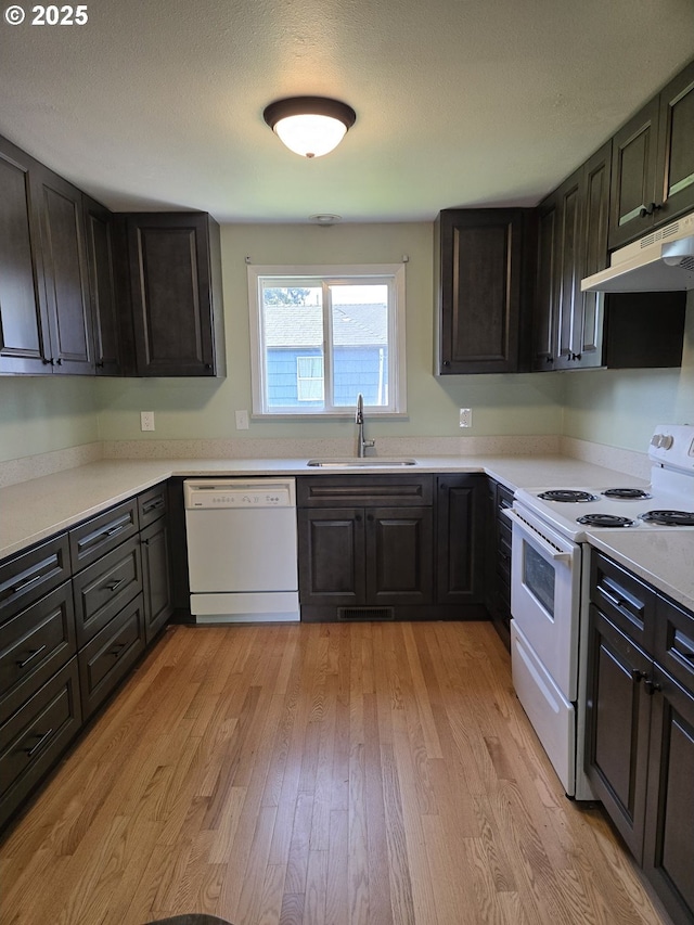 1625 Jackson St, Albany, OR 97322 - kitchen featuring white appliances, under cabinet range hood, light wood-style floors, and light countertops