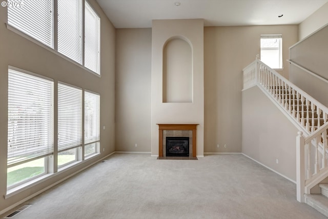 13605 NW Hogan St, Portland, OR 97229 - unfurnished living room with carpet floors, baseboards, stairs, and a fireplace