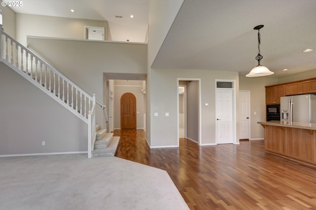 13605 NW Hogan St, Portland, OR 97229 - unfurnished living room with wood finished floors, baseboards, stairway, arched walkways, and recessed lighting