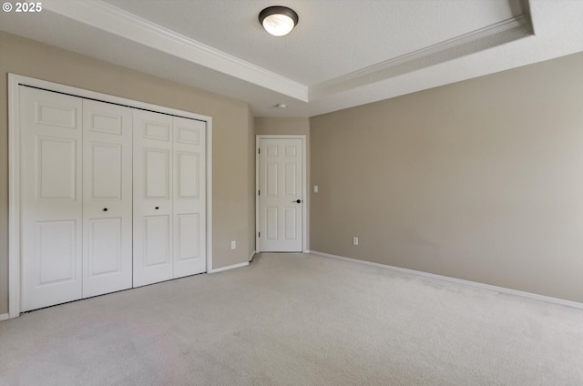 13605 NW Hogan St, Portland, OR 97229 - unfurnished bedroom with light carpet, a tray ceiling, crown molding, a closet, and baseboards