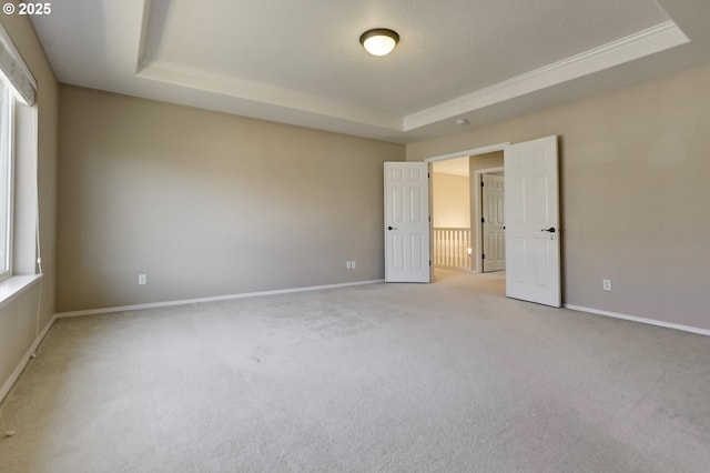 13605 NW Hogan St, Portland, OR 97229 - unfurnished bedroom with a raised ceiling, light carpet, and baseboards
